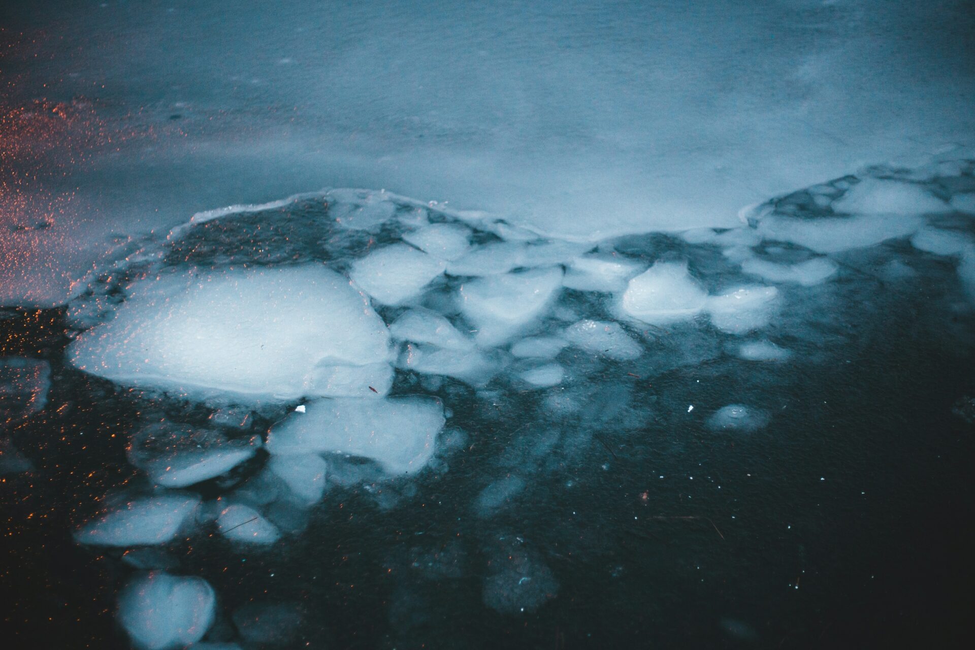 An ice shelf breaking down and melting as a result of changing climate conditions.